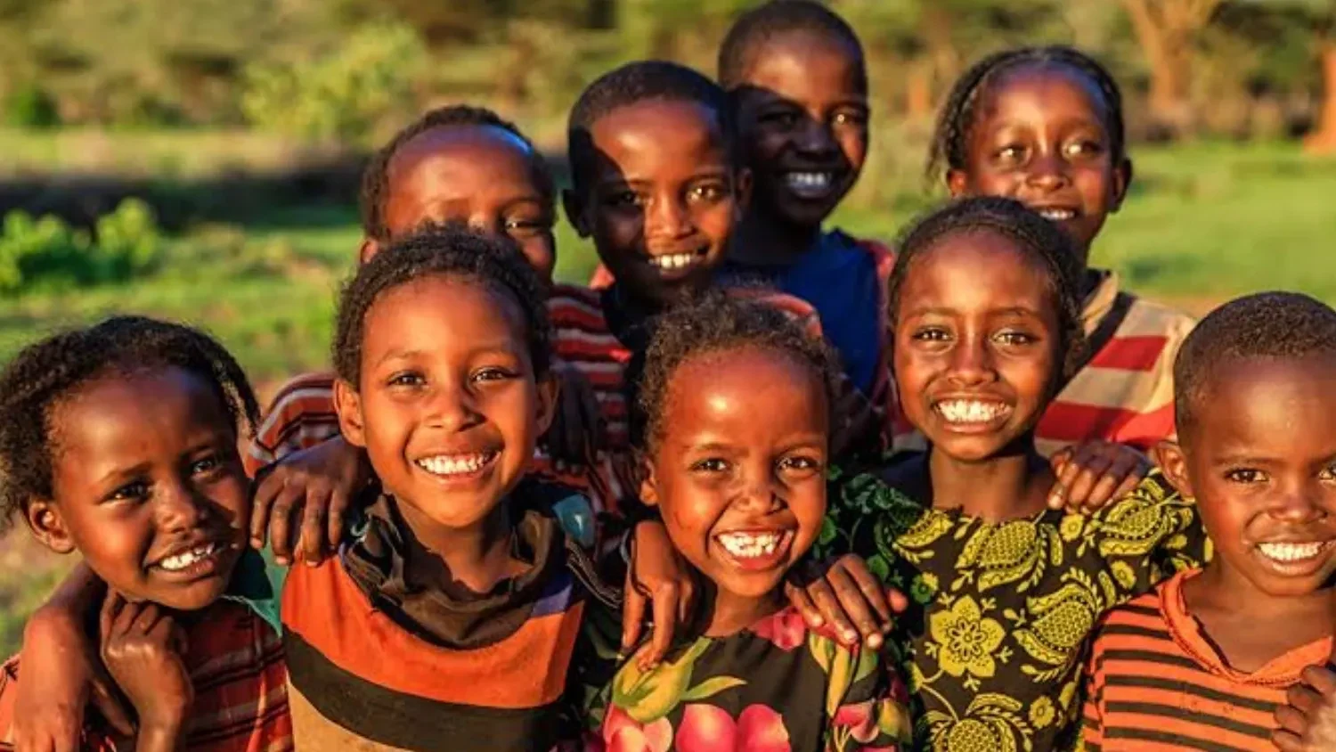Smiling children representing community impact